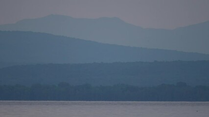 A calm landscape shot of Lake Champlain.  This is one of the many breathtaking views seen from the shores of Grand Isle, Vermont.