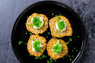 Molecular gastronomy: Keto Parmesan chips with sour cream and parsley caviar