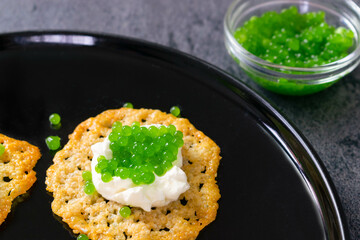 Molecular gastronomy: Keto Parmesan chips with sour cream and parsley caviar