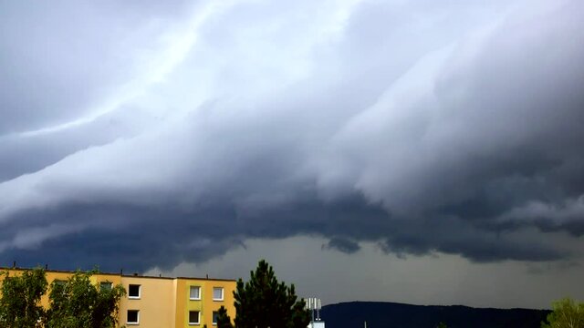 A lightning strike behind a massive shelf cloud over the city Usti nad Labem