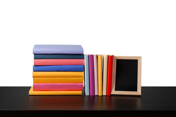 Stack of books on wooden table against white background