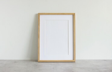 Frame mockup template on white wall  background on gray concrete desk. Copy space. Minimal concept. Interior wall accessories.
