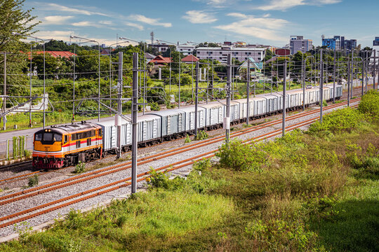 A classic old freight train running on an electric train road.