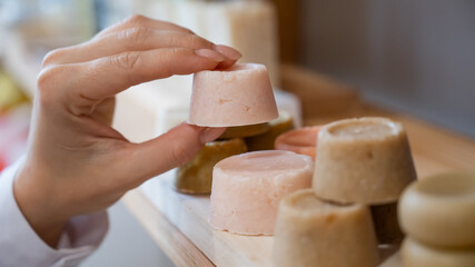 Woman chooses organic soap in eco friendly store.