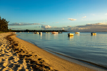 sunset on the beach with fishing boat