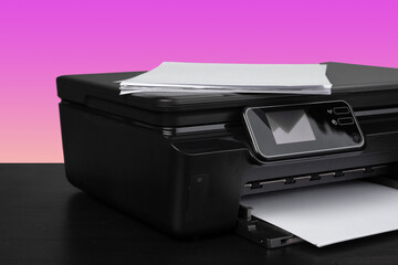 Compact home laser printer against pink background