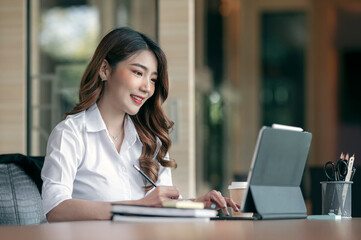 Portrait of young businesswoman working at her office with happines.