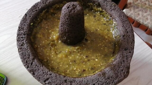 Preparing a delicious green sauce in an artisanal and organic way for some delicious tacos for cory, on a summer afternoon