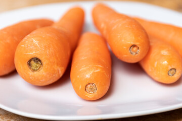 CARROTS ON WHITE PLATE MACRO PHOTOGRAPHY. selective focus