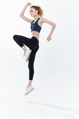 cheerful sportive woman with her leg raised workout lifestyle jumping