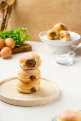 A bombolone or bomboloni is an Italian filled doughnut and is eaten as a snack food and dessert. This Bomboloni has many flavors like strawberry, chocolate, blueberry, etc.