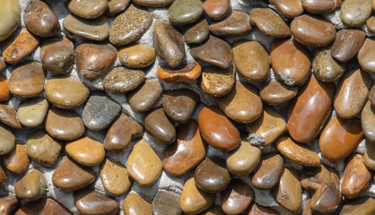 Stone pebble wall as an abstract background.