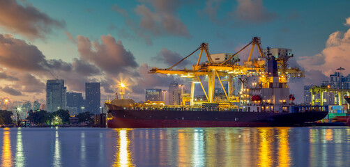 Container ship at container terminal at night, Industrial container cargo freight ship with working...