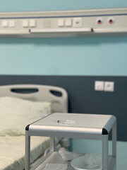 The syringe is on the bedside table in the hospital room