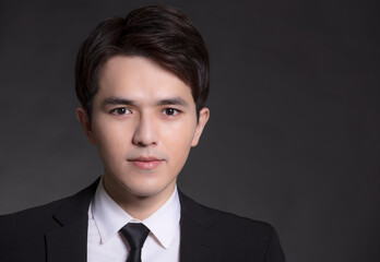 Young Asian handsome Business man in black suit