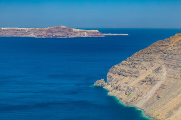 Cliff wall of Santorini island, Greece. Clear blue ocean, sea, with copy space, place for text....