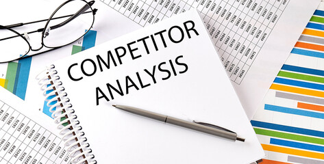 Notebook with text COMPETITOR ANALYSIS . Diagram and white background