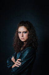Portrait of sexy young woman posing in black jacket and jeans