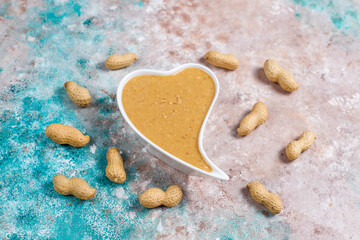 Homemade peanut butter in a jar and bowl.