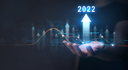 Businessman holding growth graph with year 2022. 
Corporate future growth plan in new year...