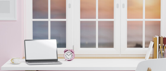 Workspace with laptop blank screen mockup and copy space on white table near window with colourful sky view