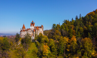 The legendary medieval Bran Castle up on a hill , the presumed residence of Vlad the Impaler , an architectural tourist attraction in Transylvania , Romania , aerial view