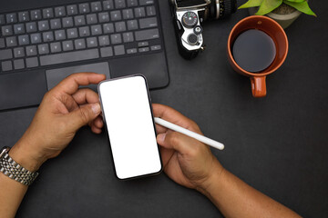 Close up, overhead male hands, reading news on the internet via smartphone