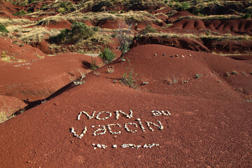 SALAGOU, FRANCE, August 2, 2021: on the red soil of Lake Salagou's shores, activists have used...