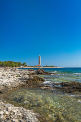 Obraz premium Lighthouse of Veli Rat on the island of Dugi Otok, Croatia, beautiful seascape and rocks in foreground