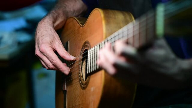 Man working at a Workshop with Musical instruments