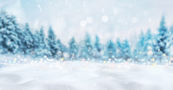 Beautiful winter natural background of snow and blurred forest, Gently falling snow flakes and christmas lights against blue morning sky, free space for your decoration.  Wide format.