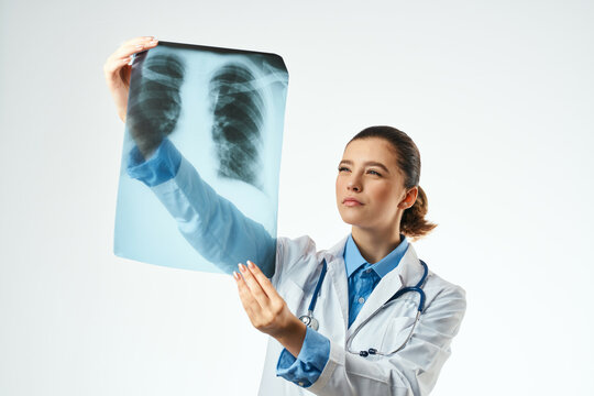female doctor x-ray white coat examination light background