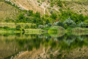 Reflection of a steep bank in the water