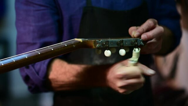 Man working at a Workshop with Musical instruments