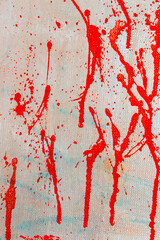 abstract creative background: red blurred spots and splashes with stains of colored primer when toning the canvas, a temporary object.
