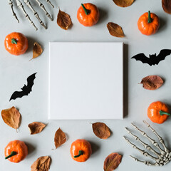 Halloween concept. Blank canvas frame and halloween decoration on grey background. Mock up poster. 