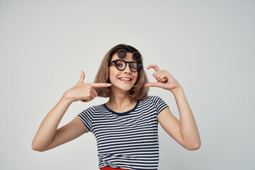 cheerful fashionable woman in striped t-shirt glasses posing summer