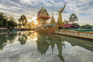 Wat Phra That Suphannahong Beautiful reflection of water in the evening SiSaKet province