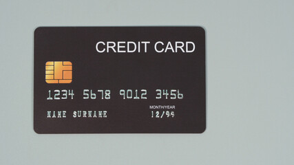 Black credit card isolated on grey background.Nopeople.