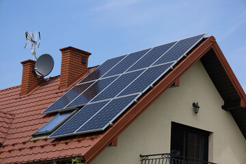 Fototapeta premium solar panels on a roof of house, modern power solution, environment friendly