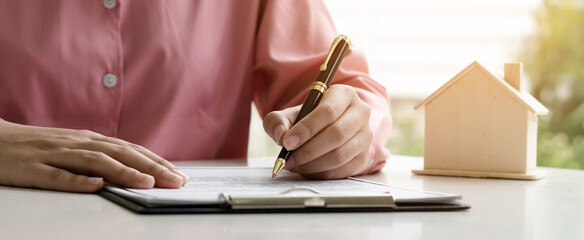 home loan insurance. .Real estate broker and client  sign contract insurance agreement document....