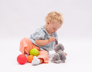Adorsble baby girl plays with toys