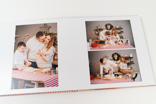 pages of photobook from a family photo shoot in kitchen