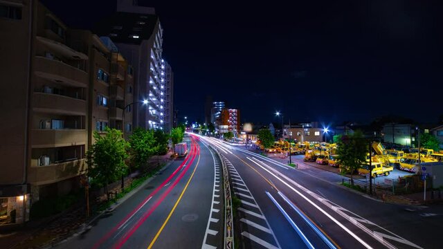 A night timelapse of traffic jam at the downtown street in Tokyo wide shot tilt