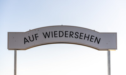 German good-bye sign against sky