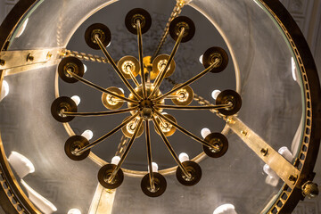 vintage lamp made of metal and glass under the ceiling close-up 