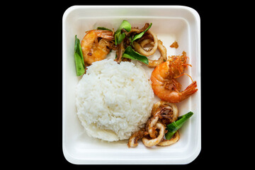 Top view of thai street food Squid and shrimp garlic and pepper with rice, focus selective