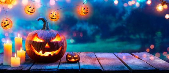 Pumpkin With Candles On Table In Garden - Halloween In Outdoor