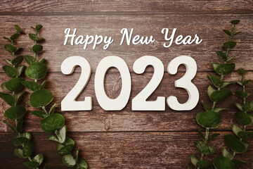 Happy New Year 2023 alphabet letter and Vintage alarm clock with space copy on wooden background