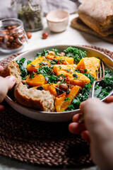 Season salad with grilled pumpkin, kale, chickpea, pepitas and nuts. Autumn vegetarian healthy recipe.